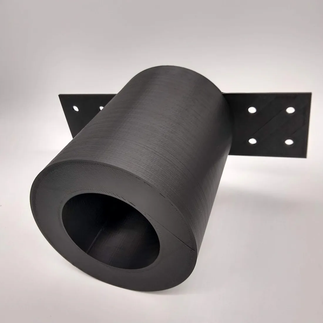 A black 3D-printed bracket formed as a curved arch.