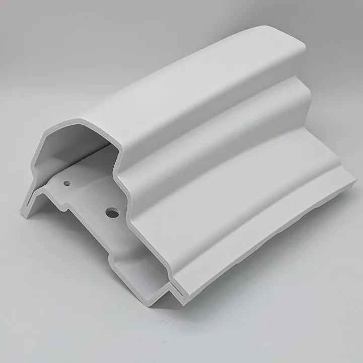 A white 3D-printed housing standing on the print bed of a 3D printer.